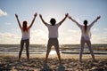 Group of people making yoga or meditating on beach Royalty Free Stock Photo
