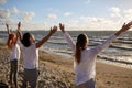 Group of people making yoga or meditating on beach Royalty Free Stock Photo