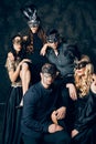 Group of people in masquerade carnival mask posing in studio