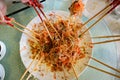 A group of people mixing and tossing Yee Sang dish with chop sticks. Royalty Free Stock Photo