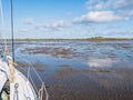 Group of people mudflat hiking on Waddensea at low tide from Friesland to West Frisian island Ameland, Netherlands Royalty Free Stock Photo