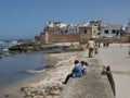 Group of people next to a wall near the fishing port of Essaouira, Morocco