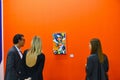 Group of people, observing a picture at an art exhibition, before the formal opening, in Turin,Italy