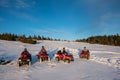 Group of people on off-road quad bikes in the the mountains in winter evening Royalty Free Stock Photo