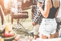 Group of people people having picnic barbecue in nature outdoor - Happy friends cooking meat and drinking wine in weekend summer Royalty Free Stock Photo