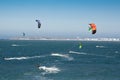 Group of people extreme action by jumping above the sea water with kitesurfing board in green color at Brighton le sands beach.