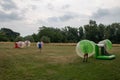 Group of people playing fun bubble football in the park Royalty Free Stock Photo