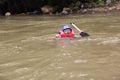 group of people playing rafting on a river that has a heavy flow,