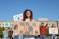 Group of people with posters protesting against climate change outdoors Royalty Free Stock Photo