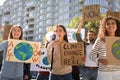 Group of people with posters protesting against climate change outdoors Royalty Free Stock Photo