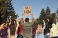Group of people with posters protesting against climate change outdoors, back view Royalty Free Stock Photo