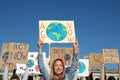 Group of people with posters protesting against climate change outdoors Royalty Free Stock Photo