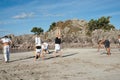 Group of people practice Capoeira on beach.