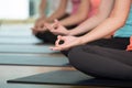 Group of people practicing yoga class, hands closeup background, sport and healthy lifestyle, wellness, well being