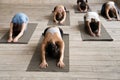 Group of people practicing yoga lesson, doing Child exercise, Ba Royalty Free Stock Photo