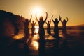 group of people practicing yoga and meditation at sunset on sunny beach, silhouette of women, generative AI Royalty Free Stock Photo