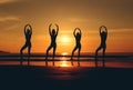 group of people practicing yoga and meditation at sunset on sunny beach, silhouette of women, generative AI Royalty Free Stock Photo