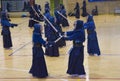 Group of people practising Kendo, a traditional japanese self defense martial art. With samurai robes and sword