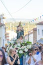 group of people in procession in honor of Santo Domingo promoted by the parish of the Portuguese village of Malpica do Tejo.