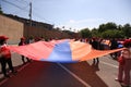 Group of people proudly displaying the Armenian flag during a celebratory parade