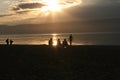 Group of people on public beach over sunset sky in Olhon, Baikal, Royalty Free Stock Photo