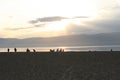 Group of people on public beach over sunset sky in Olhon, Baikal, Royalty Free Stock Photo