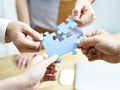 Group of people putting jigsaw pieces together Royalty Free Stock Photo