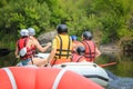 Group of people in a rafting boat, beautiful adrenaline ride down the Pacuare River,