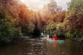 A group of people are rafting. A trip on a SAP board. A narrow river in the middle of the forest, an extreme route. bag with water