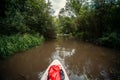 A group of people are rafting. A trip on a SAP board. A narrow river in the middle of the forest, an extreme route. bag with water