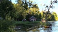 Group of people recreate on lake shore in evening sunlight