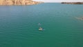 A group of people ride sup surfing in the lake.