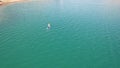 A group of people ride sup surfing in the lake.