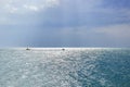 Group of people riding banana boat in the distance. Royalty Free Stock Photo