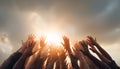 Group of people rising hands up in the air