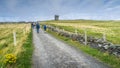 Group of people on road leading to Moher Tower at Hags Head in Cliffs of Moher, Ireland