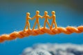 A group of people on a rope with a blue sky in the background Royalty Free Stock Photo