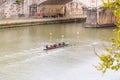 Group of people rowers canoeing in the waters of Tiber River in Rome