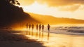 Group of people running on the beach during sunset with reflections on sand Royalty Free Stock Photo