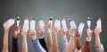 People Holding Crushed Water Bottles