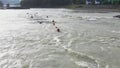 Group of people sails in the inflatable boat on the mountain river. Rafting sports