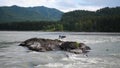 Group of people sails in the inflatable boat on the mountain river. Rafting sports