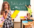 Group people schoolchild in classroom. Girl with pens on foreground.