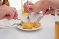 Group of people sharing a piece of Spanish omelette and drinking beer.