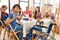 Group of people showing painted palm hands sitting on the table art studio Royalty Free Stock Photo