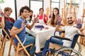 Group of people showing painted palm hands sitting on the table art studio Royalty Free Stock Photo