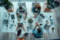 A group of people are sitting around a table in a conference room Royalty Free Stock Photo