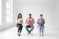 Group of people sitting on chairs and using digital devices, concept, original photoset