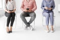 Group of people sitting on chairs and using digital devices, concept, original photoset