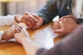 Group of people sitting in a circle holding hands and pray or in therapy session Royalty Free Stock Photo